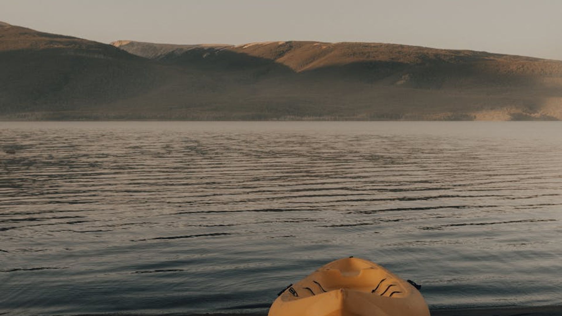 Silhouette of a woman in a dynamic cardio pose against a sunrise.